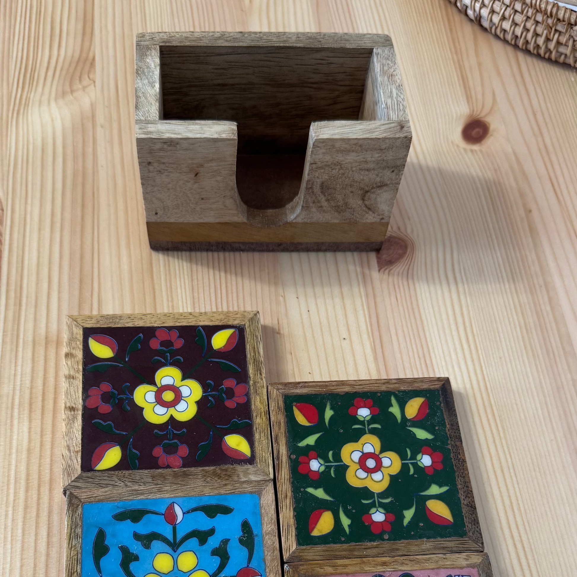 Wooden coasters with floral patterns on a wooden surface