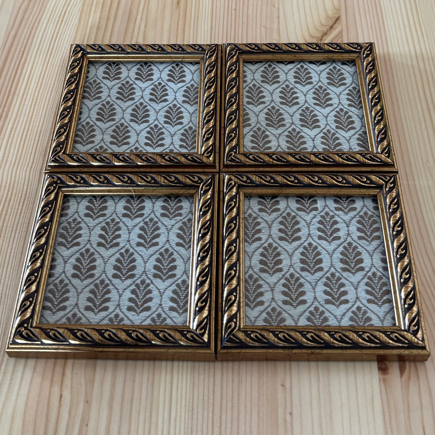 Decorative brocade coaster with a leaf pattern on a wooden surface